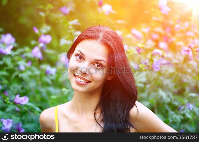 portrait of sexy girl on the background of flowers