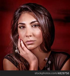 Portrait of sexy gorgeous female isolated on dark red background, beautiful fashionable makeup, healthy glossy hair, beauty salon concept