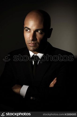 Portrait of sexy male wearing black suit, white shirt and stylish tie isolated on gray background, luxury lifestyle, business and job concept&#xA;