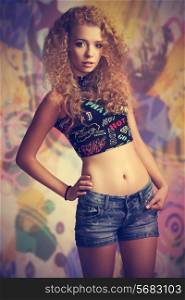 portrait of sexy young female with casual trendy style and long curly blonde hair