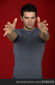 Portrait of sexy young man, against red background