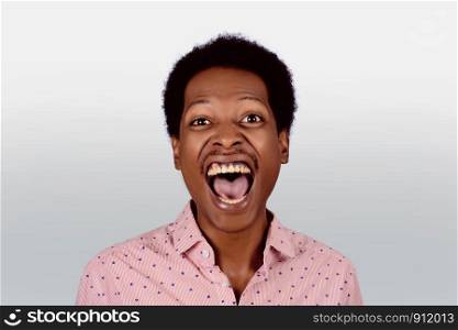 Portrait of shocked Afro American man on studio. Black male with surpised expression.