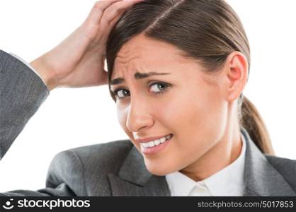 Portrait of shocked and confused business woman holding her head with hand on white background