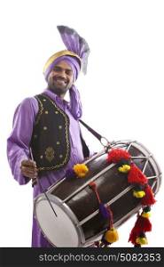 Portrait of Sikh man playing on drums