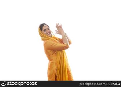Portrait of Sikh woman doing bhangra dance