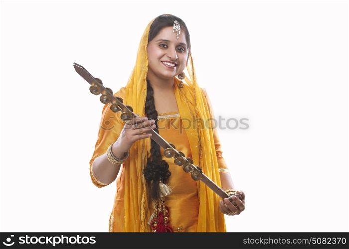 Portrait of Sikh woman holding a chimta