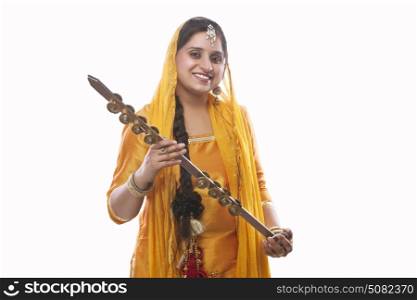 Portrait of Sikh woman holding a chimta