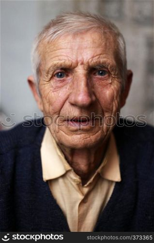 portrait of sitting senior man at home