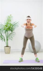 Portrait of slim young woman making fitness exercises