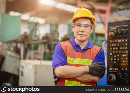 Portrait of smart engineer Asian Chinese happy labor worker handsome model in heavy industry  background.arm folded cross and smiling.