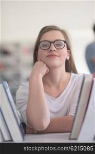 portrait of smart looking famale student girl in collage school library, selecting book to read from bookshelf