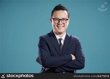 Portrait of smile asian businessman in suit . isolated on light blue background .