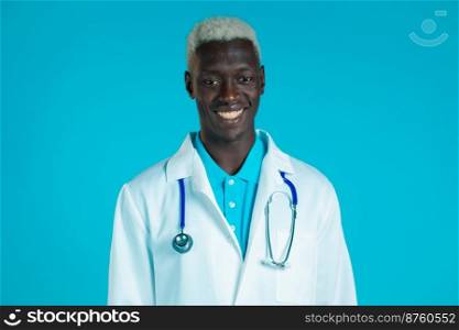 Portrait of smiling african doctor in professional medical coat . Doc man isolated on blue background. Portrait of smiling african doctor in professional medical coat . Doc man isolated on blue background.