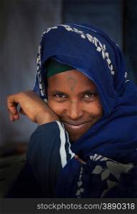 Portrait of smiling Amhara woman wearing blue traditional clothing, Ethiopia, Africa