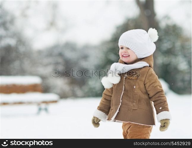 Portrait of smiling baby in winter park