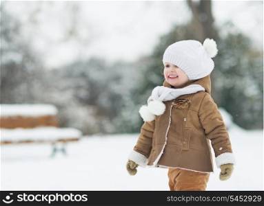 Portrait of smiling baby in winter park