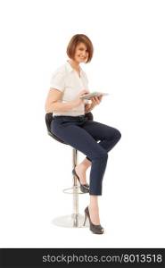 Portrait of smiling beautiful businesswoman sitting on chair, holding tablet. Isolated, studio shot.