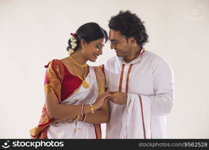 Portrait of smiling Bengali couple against white background 