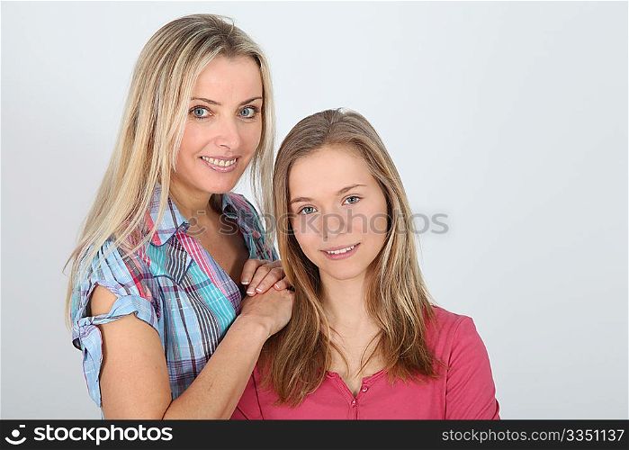 Portrait of smiling blond mother and daughter