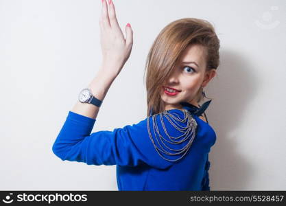 Portrait of smiling blond woman with hand up, side view