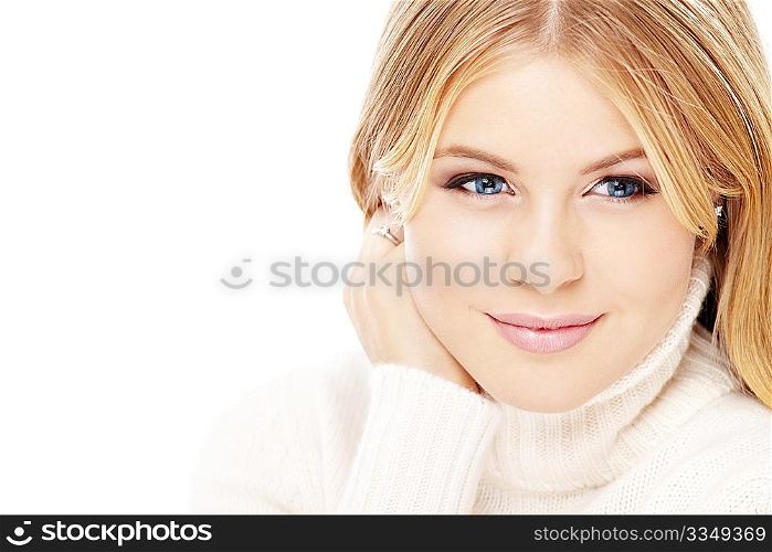 Portrait of smiling blonde in the white sweater, isolated