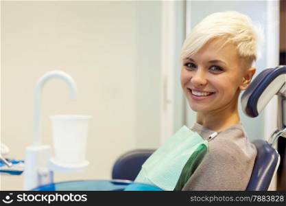 portrait of smiling blonde woman at the dentist