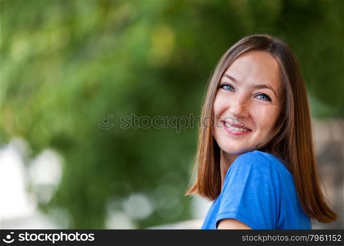 Portrait of smiling brunette woman outdoor