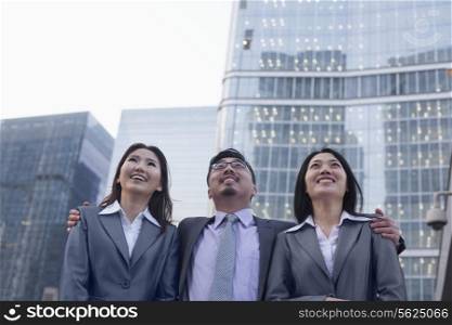 Portrait of smiling business people in a row outdoors, Beijing