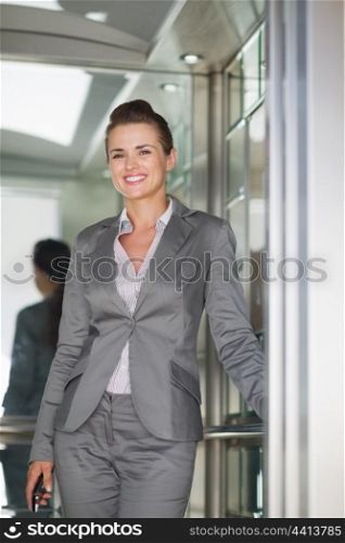 Portrait of smiling business woman in elevator