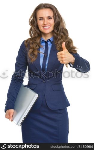Portrait of smiling business woman with laptop showing thumbs up