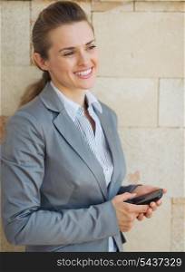 Portrait of smiling business woman with mobile phone