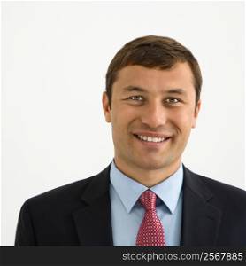 Portrait of smiling businessman against white background.