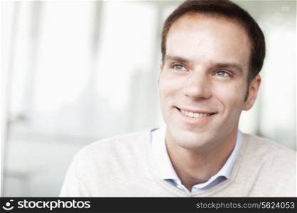 Portrait of smiling businessman in casual clothing looking away