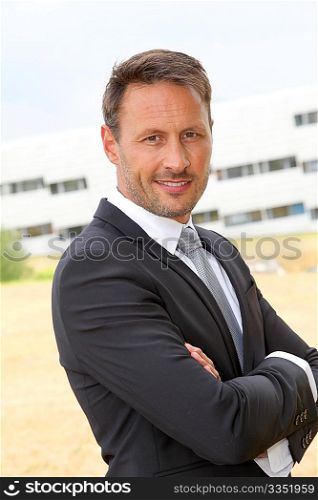 Portrait of smiling businessman in dark suit