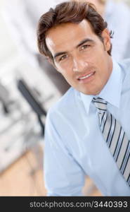 Portrait of smiling businessman in office