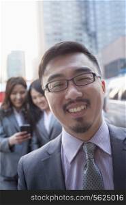 Portrait of smiling businessman outdoors, Beijing
