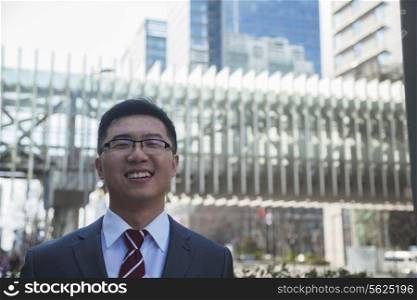 Portrait of smiling businessman outdoors in Beijing, China