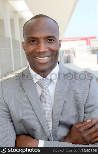Portrait of smiling businessman standing outdoors
