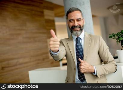 Portrait of smiling businessman with a thumb up
