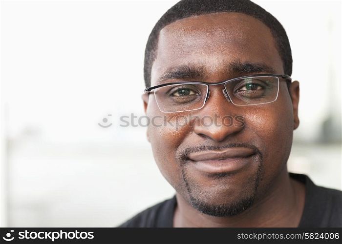 Portrait of smiling businessman with glasses looking at camera