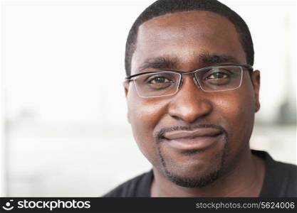 Portrait of smiling businessman with glasses looking at camera