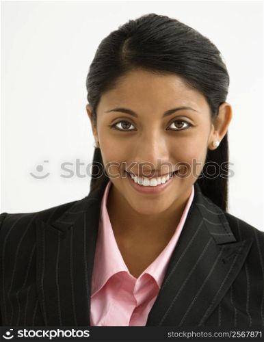 Portrait of smiling businesswoman against white background.