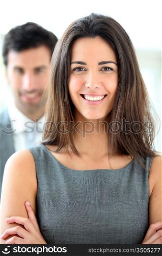 Portrait of smiling businesswoman wearing grey dress