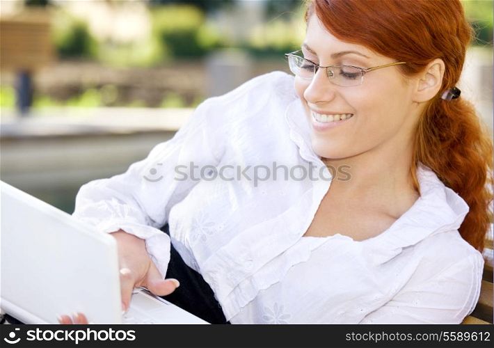 portrait of smiling businesswoman with laptop computer