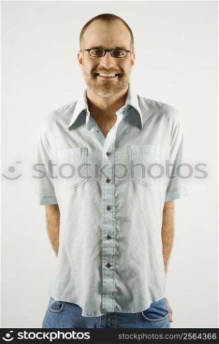 Portrait of smiling Caucasian man wearing eyeglasses standing against white background.