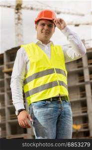 Portrait of smiling construction engineer wearing hardhat
