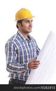Portrait of smiling contractor holding blueprint