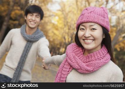 Portrait of Smiling Couple Holding Hands in Park