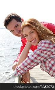 Portrait of smiling couple standing by a lake