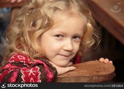 portrait of smiling curly little girl indoors